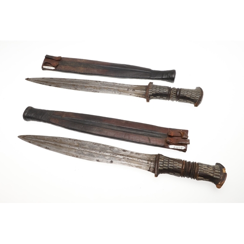 108 - A NEAR IDENTICAL PAIR OF SUDANESE KNIVES AND SCABBARDS. The two blades 32 cm and 30 cm, with curved ... 