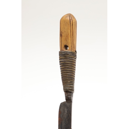 116 - A SOUTH ALGERIAN BOU SADDI KNIFE AND SCABBARD. The 13.5 cm slender pointed blade with engraved decor... 