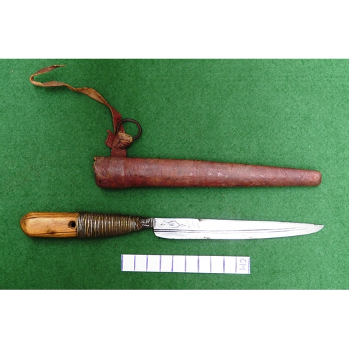 116 - A SOUTH ALGERIAN BOU SADDI KNIFE AND SCABBARD. The 13.5 cm slender pointed blade with engraved decor... 