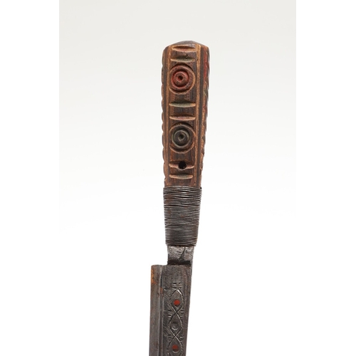 117 - A SOUTH ALGERIAN BOU SADDI KNIFE AND SCABBARD. The 13.5 cm pointed blade with red dot decoration, on... 