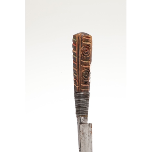117 - A SOUTH ALGERIAN BOU SADDI KNIFE AND SCABBARD. The 13.5 cm pointed blade with red dot decoration, on... 