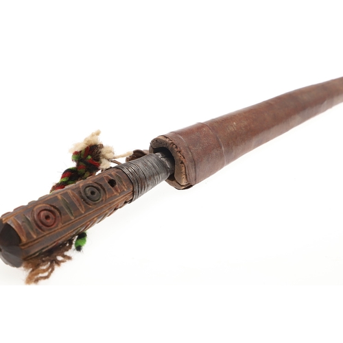 117 - A SOUTH ALGERIAN BOU SADDI KNIFE AND SCABBARD. The 13.5 cm pointed blade with red dot decoration, on... 