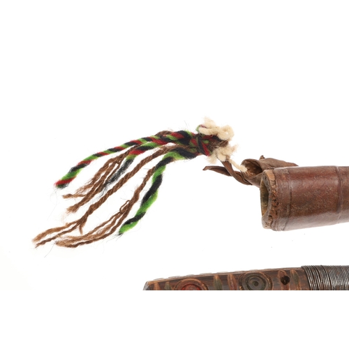 117 - A SOUTH ALGERIAN BOU SADDI KNIFE AND SCABBARD. The 13.5 cm pointed blade with red dot decoration, on... 