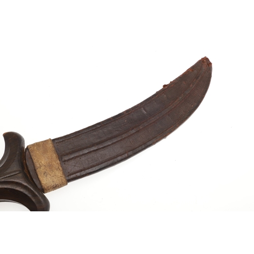 118 - A BEDJA ERITREAN KNIFE WITH X FORM HANDLE. The 20 cm hooked blade with a pointed tip sharpened to bo... 