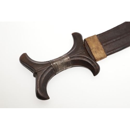 118 - A BEDJA ERITREAN KNIFE WITH X FORM HANDLE. The 20 cm hooked blade with a pointed tip sharpened to bo... 