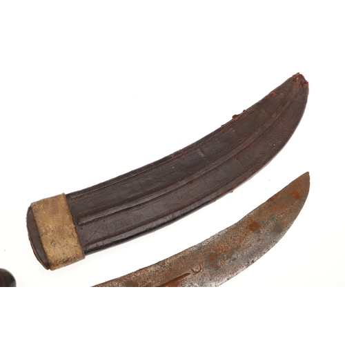 118 - A BEDJA ERITREAN KNIFE WITH X FORM HANDLE. The 20 cm hooked blade with a pointed tip sharpened to bo... 