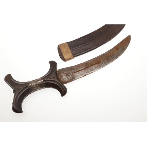 118 - A BEDJA ERITREAN KNIFE WITH X FORM HANDLE. The 20 cm hooked blade with a pointed tip sharpened to bo... 