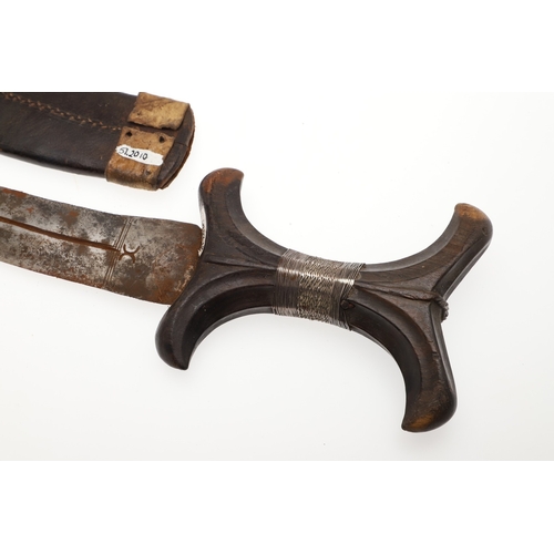 118 - A BEDJA ERITREAN KNIFE WITH X FORM HANDLE. The 20 cm hooked blade with a pointed tip sharpened to bo... 