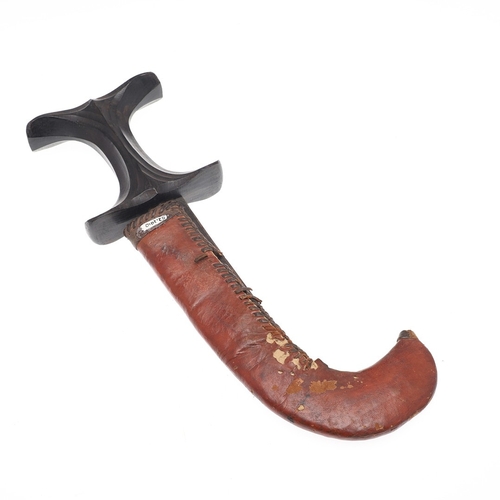 119 - A BEDJA ERITREAN KNIFE WITH 'X' FORM HANDLE. The knife having a 21 cm hooked blade sharpened to both... 