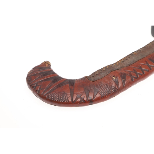 119 - A BEDJA ERITREAN KNIFE WITH 'X' FORM HANDLE. The knife having a 21 cm hooked blade sharpened to both... 