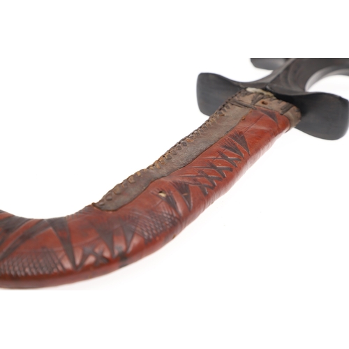 119 - A BEDJA ERITREAN KNIFE WITH 'X' FORM HANDLE. The knife having a 21 cm hooked blade sharpened to both... 