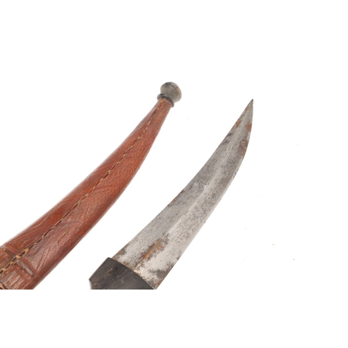 139 - A DAGGER AND SCABBARD, POSSIBLY MARSH ARAB. The short 14 cm curved, pointed and double edged blade w... 