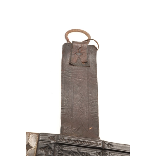 160 - A TAKOUBA SWORD AND SCABBARD OF THE TUAREG PEOPLE. The 79 cm straight tapering blade with rounded po... 