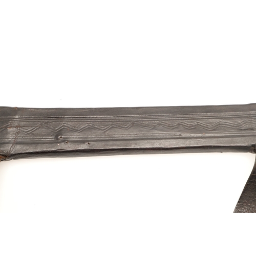 160 - A TAKOUBA SWORD AND SCABBARD OF THE TUAREG PEOPLE. The 79 cm straight tapering blade with rounded po... 