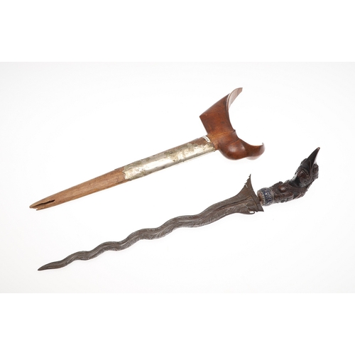37 - A 19TH CENTURY JEWEL ENCRUSTED KRIS AND SCABBARD. The 34 cm blade with ten curves and pamor in the '... 