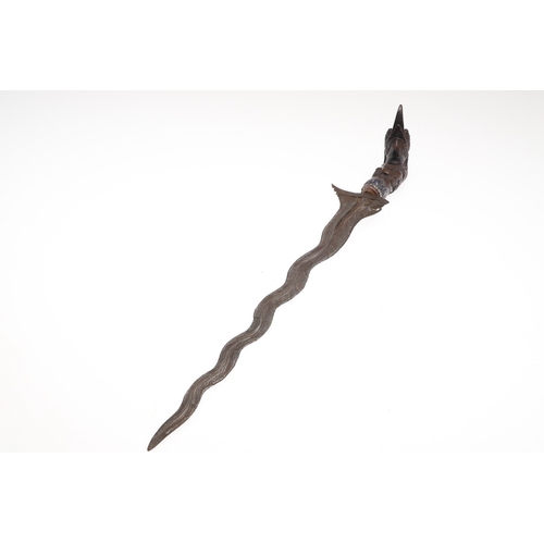 37 - A 19TH CENTURY JEWEL ENCRUSTED KRIS AND SCABBARD. The 34 cm blade with ten curves and pamor in the '... 