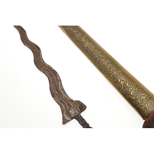 43 - A FINE KRIS MAJAPAHIT AND SCABBARD. With a 20 cm seven curved blade showing a pronounced pamor. The ... 