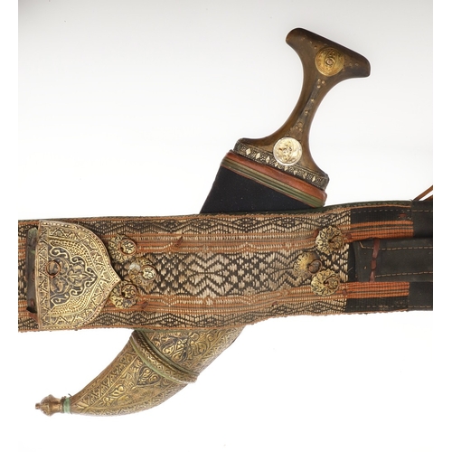 63 - A YEMENI JANABI KNIFE AND SCABBARD ON THE ORIGINAL BROAD BELT. The knife with a 22 cm curved blade w... 