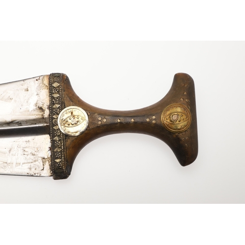 63 - A YEMENI JANABI KNIFE AND SCABBARD ON THE ORIGINAL BROAD BELT. The knife with a 22 cm curved blade w... 