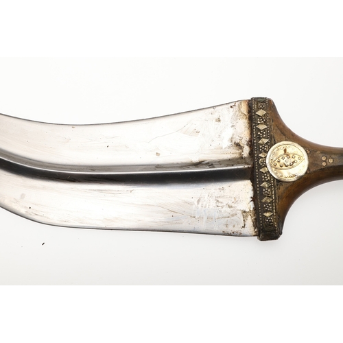 63 - A YEMENI JANABI KNIFE AND SCABBARD ON THE ORIGINAL BROAD BELT. The knife with a 22 cm curved blade w... 