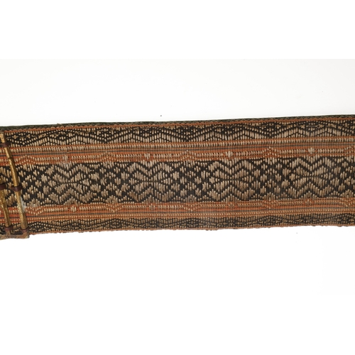 63 - A YEMENI JANABI KNIFE AND SCABBARD ON THE ORIGINAL BROAD BELT. The knife with a 22 cm curved blade w... 