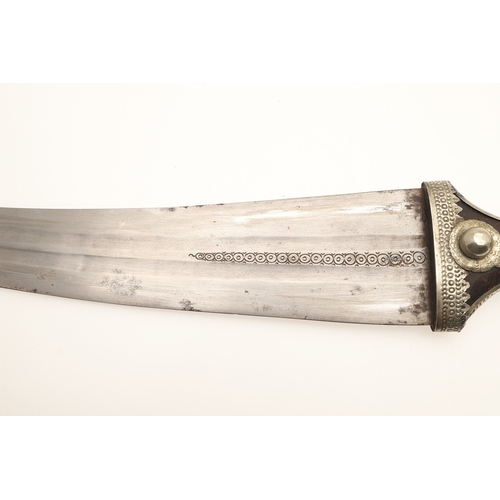 64 - A FINE LONG BLADED JANBIYYA AND SCABBARD. A Janbiyya having a 37 cm curved blade with shallow fuller... 