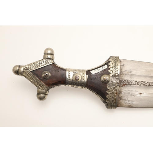 64 - A FINE LONG BLADED JANBIYYA AND SCABBARD. A Janbiyya having a 37 cm curved blade with shallow fuller... 
