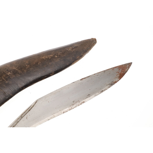 69 - A KUKRI KNIFE AND SCABBARD. With a traditionally shaped 25 cm pointed blade on a hardwood handle. In... 