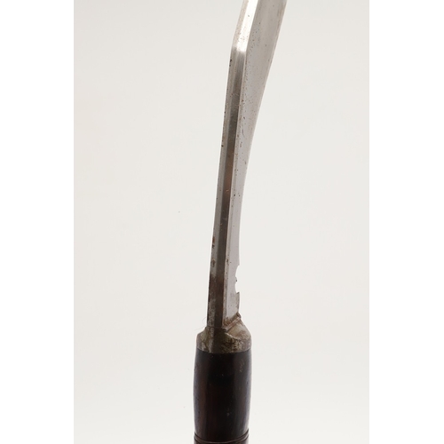 69 - A KUKRI KNIFE AND SCABBARD. With a traditionally shaped 25 cm pointed blade on a hardwood handle. In... 