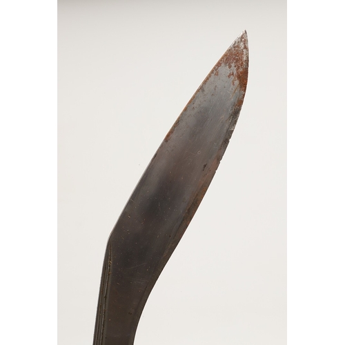 69 - A KUKRI KNIFE AND SCABBARD. With a traditionally shaped 25 cm pointed blade on a hardwood handle. In... 
