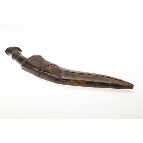 69 - A KUKRI KNIFE AND SCABBARD. With a traditionally shaped 25 cm pointed blade on a hardwood handle. In... 
