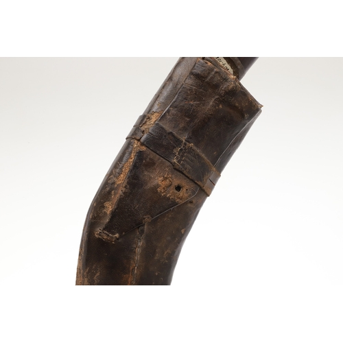 69 - A KUKRI KNIFE AND SCABBARD. With a traditionally shaped 25 cm pointed blade on a hardwood handle. In... 