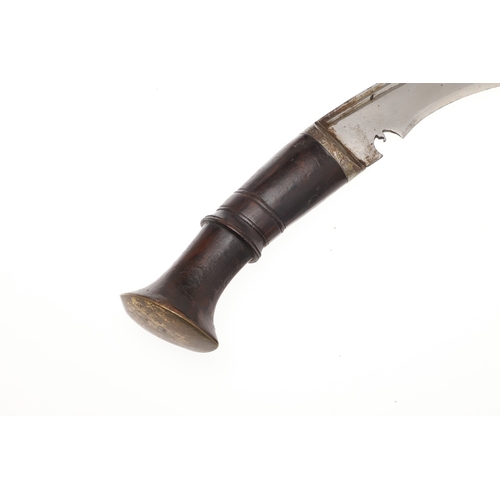 69 - A KUKRI KNIFE AND SCABBARD. With a traditionally shaped 25 cm pointed blade on a hardwood handle. In... 
