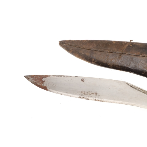69 - A KUKRI KNIFE AND SCABBARD. With a traditionally shaped 25 cm pointed blade on a hardwood handle. In... 