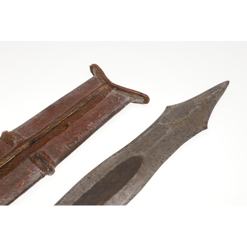 99 - A SALAMPASU KNIFE AND SCABBARD FROM SOUTHERN ZAIRE. The 45 cm blade of irregular outline with pointe... 