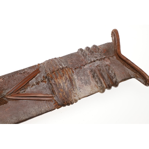 99 - A SALAMPASU KNIFE AND SCABBARD FROM SOUTHERN ZAIRE. The 45 cm blade of irregular outline with pointe... 
