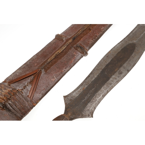 99 - A SALAMPASU KNIFE AND SCABBARD FROM SOUTHERN ZAIRE. The 45 cm blade of irregular outline with pointe... 