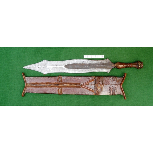 99 - A SALAMPASU KNIFE AND SCABBARD FROM SOUTHERN ZAIRE. The 45 cm blade of irregular outline with pointe... 