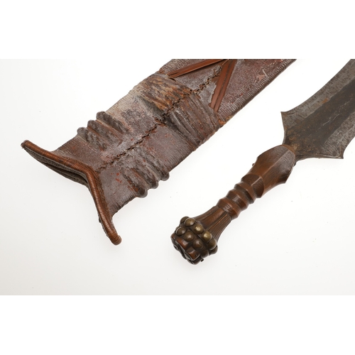 99 - A SALAMPASU KNIFE AND SCABBARD FROM SOUTHERN ZAIRE. The 45 cm blade of irregular outline with pointe... 