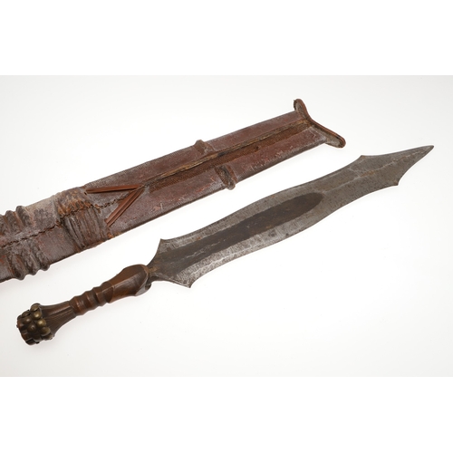 99 - A SALAMPASU KNIFE AND SCABBARD FROM SOUTHERN ZAIRE. The 45 cm blade of irregular outline with pointe... 