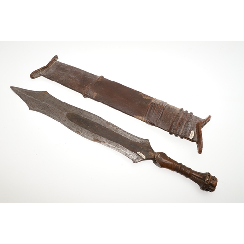 99 - A SALAMPASU KNIFE AND SCABBARD FROM SOUTHERN ZAIRE. The 45 cm blade of irregular outline with pointe... 