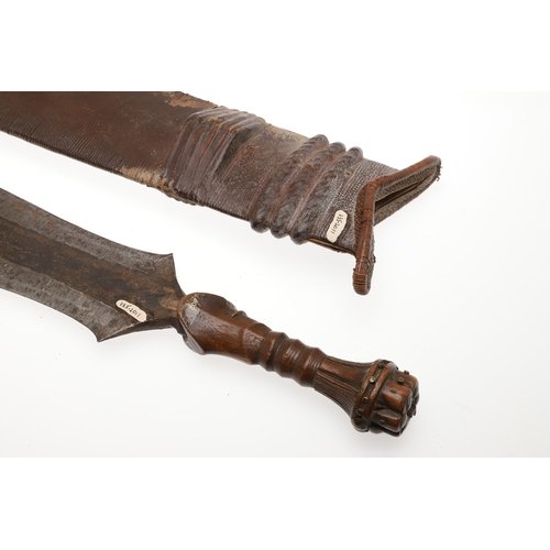 99 - A SALAMPASU KNIFE AND SCABBARD FROM SOUTHERN ZAIRE. The 45 cm blade of irregular outline with pointe... 