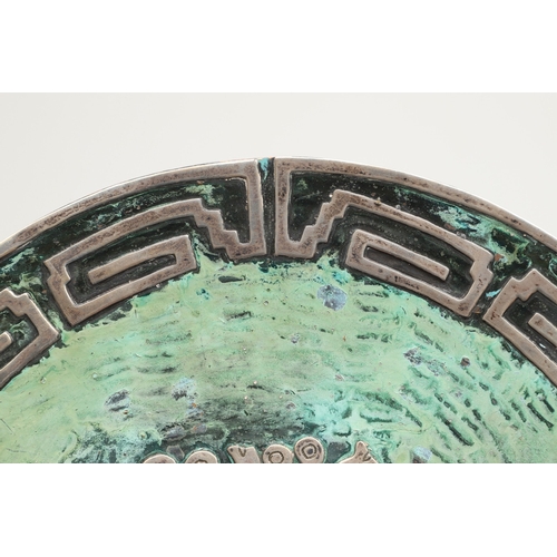 104 - GRAZIELLA LAFFI. TWO COPPER AND SILVER PERUVIAN STYLE ART PIECES. To include a plate (Diameter 25cm)... 