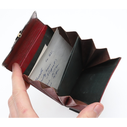 107 - AN EIGHTEENTH CENTURY SILVER MOUNTED WALLET. of red morocco leather with pierced silver mounts and l... 