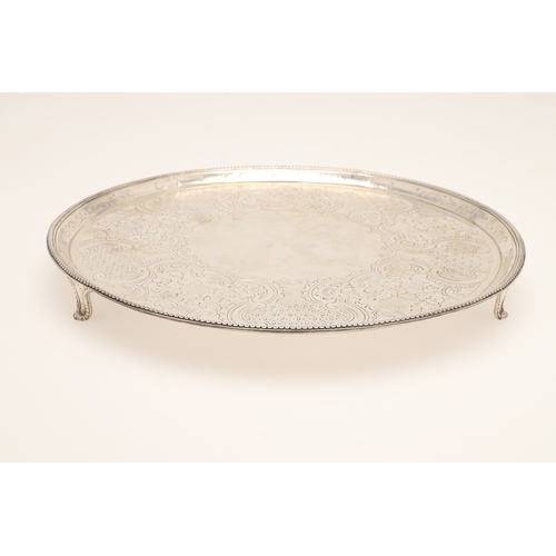 23 - A GEORGE III SILVER SALVER. Of circular form, with later chased foliate, grape vine and other decora... 