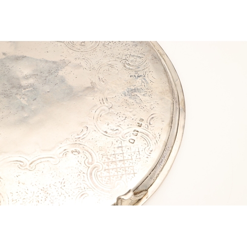 23 - A GEORGE III SILVER SALVER. Of circular form, with later chased foliate, grape vine and other decora... 
