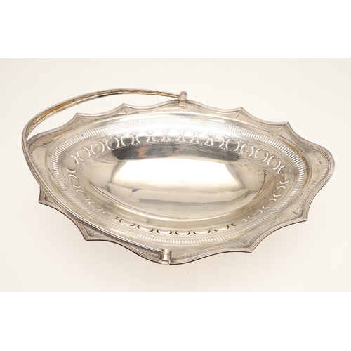 24 - A GEORGE III SILVER CAKE OR BREAD BASKET. Of shaped oval form with a reeded border, pierced and engr... 