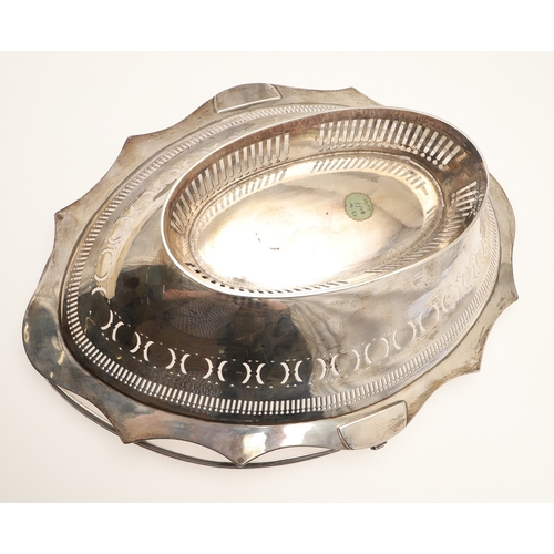24 - A GEORGE III SILVER CAKE OR BREAD BASKET. Of shaped oval form with a reeded border, pierced and engr... 