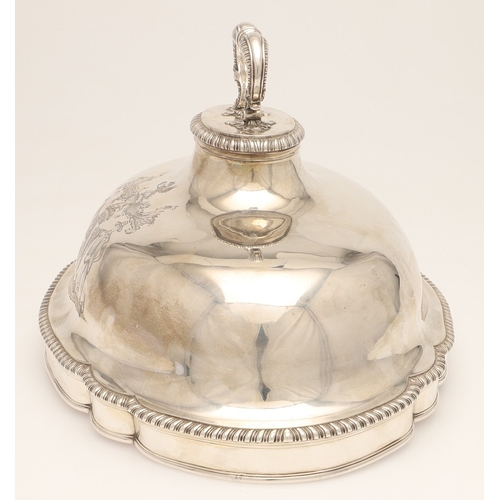 25 - A GEORGE III CRESTED SILVER MEAT DISH COVER. Of shaped-serpentine form, with gadrooned rim, engraved... 