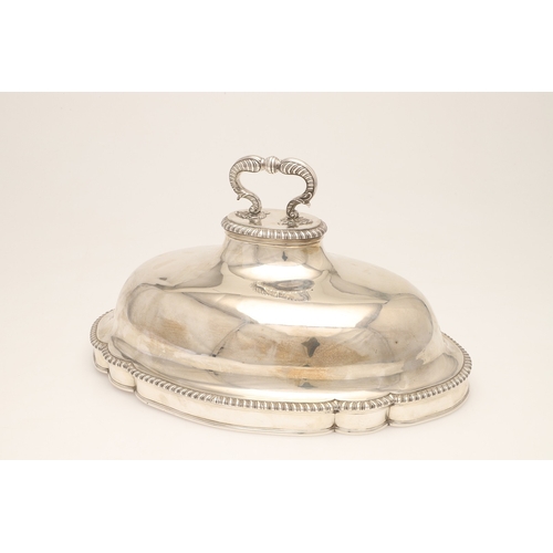 25 - A GEORGE III CRESTED SILVER MEAT DISH COVER. Of shaped-serpentine form, with gadrooned rim, engraved... 